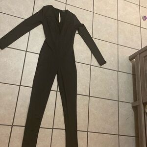 Fashion nova, Black jumpsuit . small .stretchy material. Very low front V-neck.